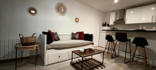 un salon avec un canapé et une cuisine dans l'établissement Studio paisible en centre ville, au Havre