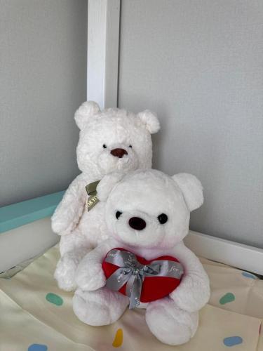 two white teddy bears sitting next to each other at Luxury Escape Spacious Stay with Pool and Terrace in Luanda