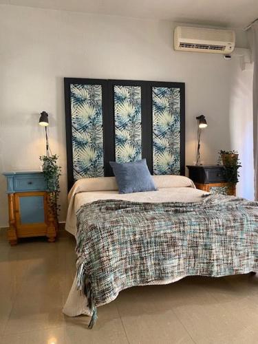 a bedroom with a bed with a blue pillow on it at Acogedores apartamentos en el centro in Alcantarilla