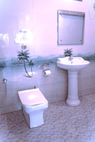 a bathroom with a sink and a toilet and a mirror at This is it Beachfront - Rooms, Cafe & Events in Arambol