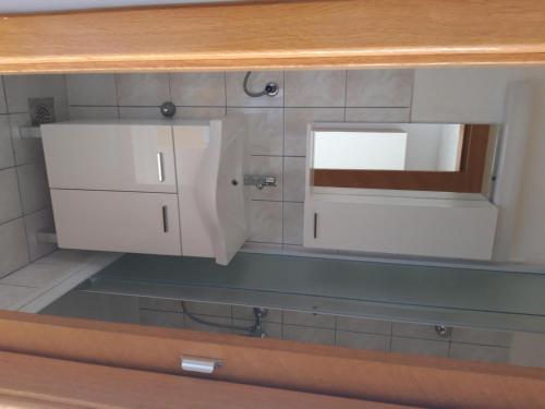 a kitchen with a sink and a mirror on a counter at House Nikola in Tučepi