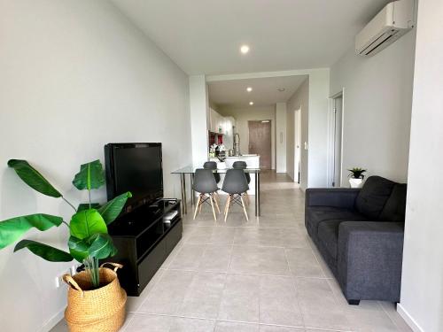 a living room with a couch and a table at 2 Bedroom aparment with Views and parking in Garden City in Brisbane