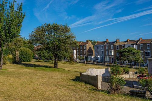 a park in a town with houses in the background at Lovely house on Trinity Square, edge of Old Town in Margate