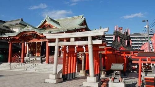 a building with red pillars in a city at trias527 4-3 in Tokyo