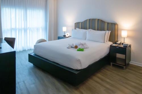 a bedroom with a large bed with two teddy bears on it at Meliá Orlando Celebration in Orlando