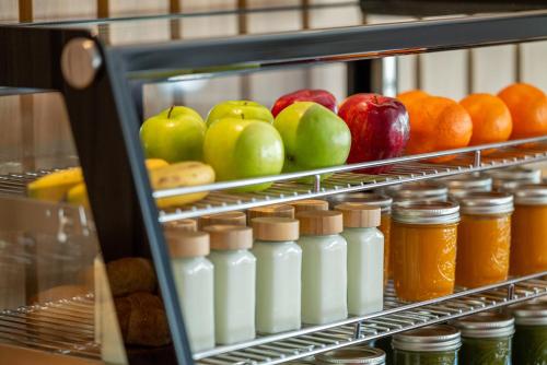 a shelf in a refrigerator filled with milk and fruit at Meliá Orlando Celebration in Orlando