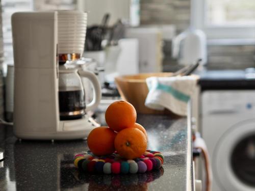 a pile of oranges on a counter in a kitchen at Central 3 Bed House with Parking in Oxford