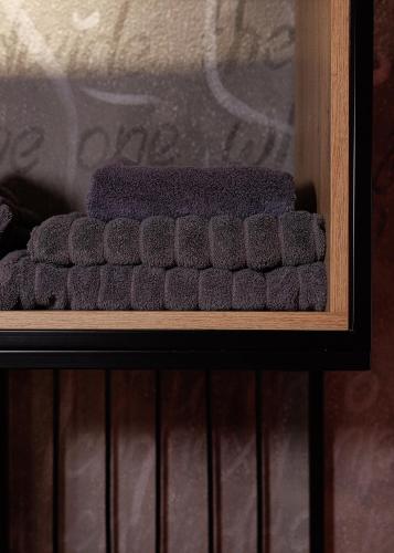 a pile of grey scrubs sitting on a shelf at Masoch. Hotel & Cafe in Lviv