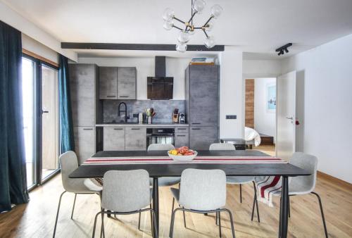 a kitchen and dining room with a table and chairs at Apartment Aiguille Rose in Les Houches