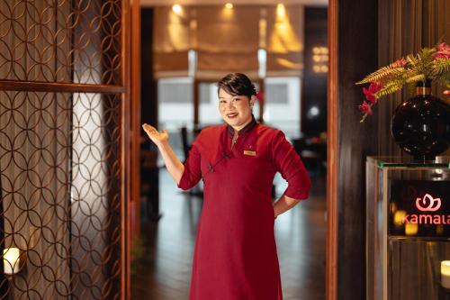 a woman in a red dress standing in a building at Sofitel Cairo Downtown Nile in Cairo
