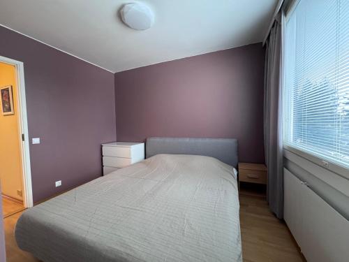 a small bedroom with a bed and a window at Park View Apart in Kouvola