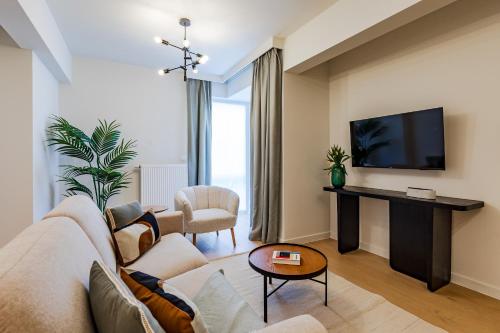 a living room with a couch and a tv at Diamant 1BR in Brussels