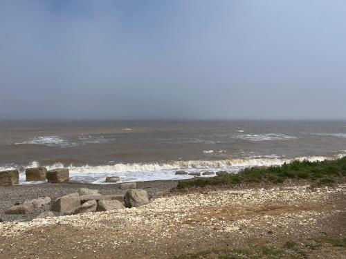 a group of rocks on a beach near the ocean at Lucys Pad in Hull