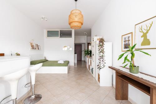 a living room with a couch and a table at Tiny Boho Chic in Lido di Ostia