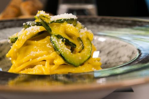a plate of food with cheese and green peppers at Massimi City Garden in Rome