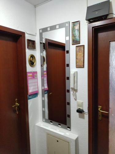 a mirror on a wall next to a door at Apartment Hercules in Öhringen