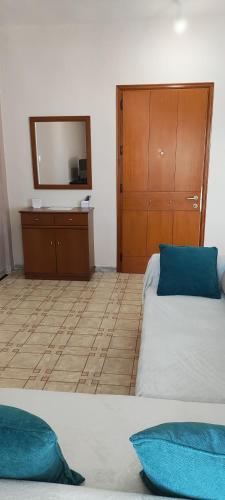 a room with a bed and a dresser with a mirror at Σαν Στο Σπίτι Σας in Xanthi