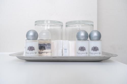 a tray with glass jars and spoons on a shelf at By the Sea - Nazaré in Nazaré