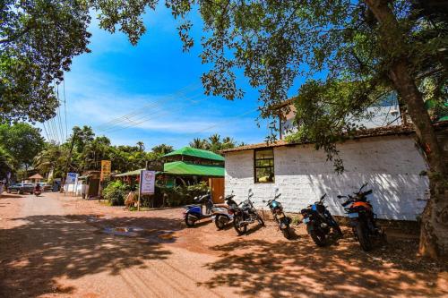 a group of motorcycles parked next to a building at YogiTree Beach Resort & Cafe - 100m from Morjim Beach in Morjim