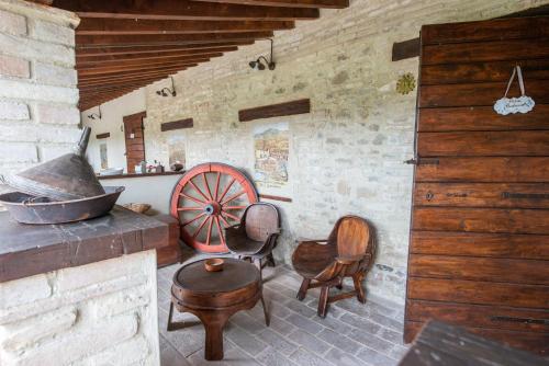 a room with a stove and chairs in a building at TORRE QUADRANA in Spello