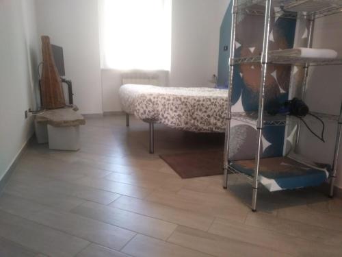 a room with a bed and a wooden floor at San Salvario No cooking between history and nightlife in Turin