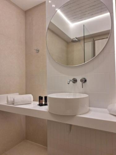 a bathroom with a sink and a mirror at Kos Palace in Tigaki