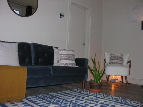 a living room with a blue couch and a chair at Carlisle at No12 in Carlisle