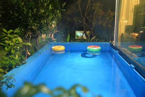 a blue table with three bowls on top of it at Timi Little Garden in Ba Vì