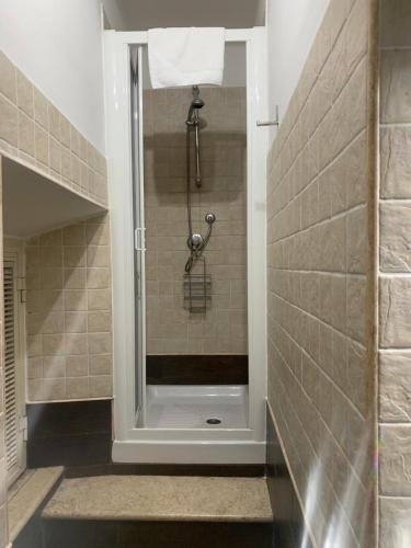 a shower with a glass door in a bathroom at B&B La Cupella in Monterotondo