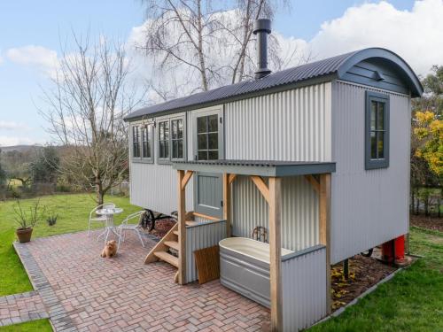 a tiny house with a porch and a patio at Evendine Hut Evendine Cottage in Little Malvern