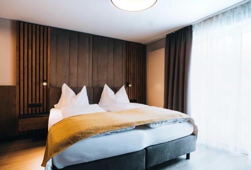 Postel nebo postele na pokoji v ubytování Grünwald Resort Sölden