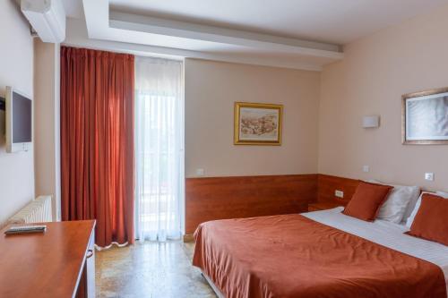 a hotel room with two beds and a window at Hotel Sileks in Ohrid