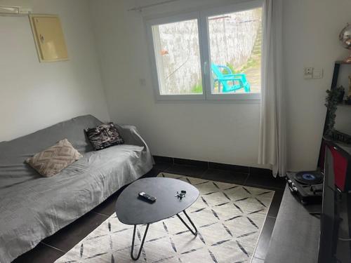 un salon avec un canapé et une table dans l'établissement Maison individuelle type F2, à Alata