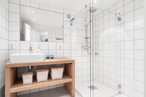 a bathroom with a sink and a shower at Spacious and Modern Fisherman's Cabin in Stamsund