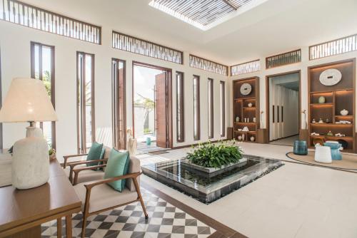 a living room with a pool in the middle of the room at The Ocean Resort by Fusion Quy Nhon in Quy Nhon