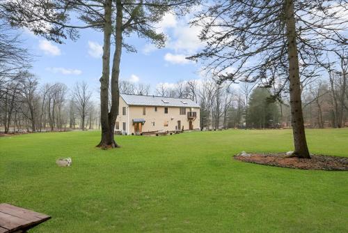 a house in the middle of a field with trees at Nature Getaway Charming Villa Near Trails & Parks in Monroe