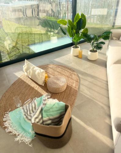 a room with a table with a hat and a basket at Amber Skies Seafront Retreat in El Cotillo