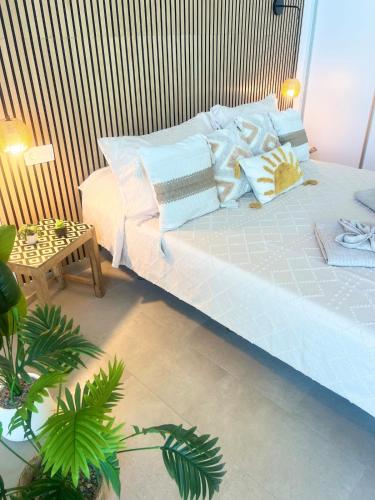 a bedroom with a large bed with pillows at Amber Skies Seafront Retreat in El Cotillo