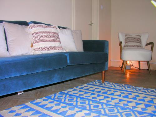 a blue couch and a chair in a living room at Carlisle at No12 in Carlisle