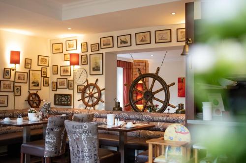 a dining room with tables and a large mirror at Park Hotel Sellin in Ostseebad Sellin