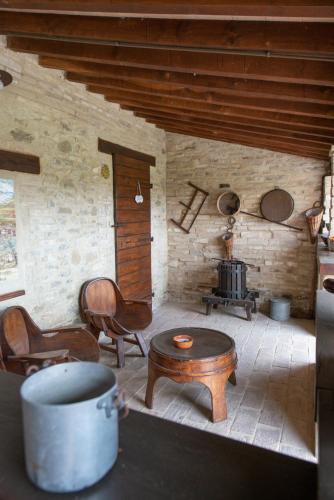 a living room with a table and a stove at TORRE QUADRANA in Spello