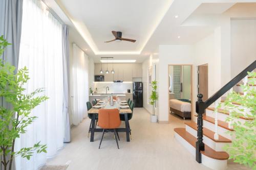 a dining room and kitchen with a table and chairs at Patong private pool Villa 5BR 4Bath By MP property in Patong Beach