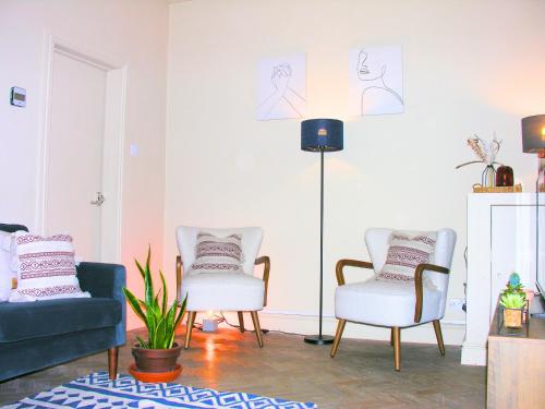 a living room with two chairs and a lamp at Carlisle at No12 in Carlisle