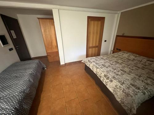 a bedroom with a bed and a pillow in it at Hotel Tenuta dell'Argento Resort in Civitavecchia