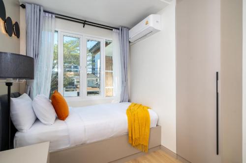 a bedroom with a bed and a window at Patong private pool Villa 5BR 4Bath By MP property in Patong Beach