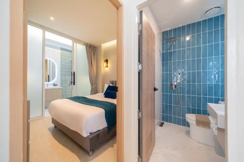 a bedroom with a bed and a bathroom with a sink at Patong private pool Villa 5BR 4Bath By MP property in Patong Beach