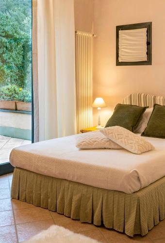 a large bed in a bedroom with a window at Casa Armonia by Vayadù in Alassio