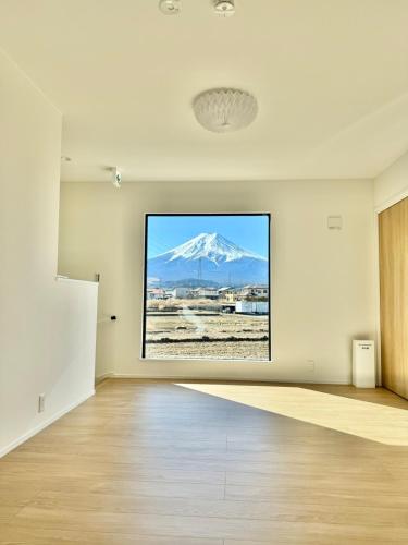 an empty room with a picture of a snow covered mountain at 富士の宿燦々 in Fujiyoshida