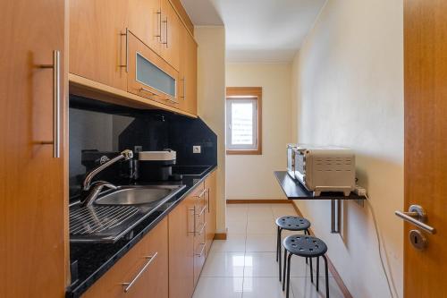 a small kitchen with a sink and a counter at GuestReady - Pleasant Hideway in Porto in Porto