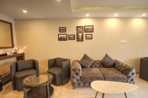 a living room with a couch and two chairs at The Bunkk Inn Hotel & Restaurant in Mussoorie